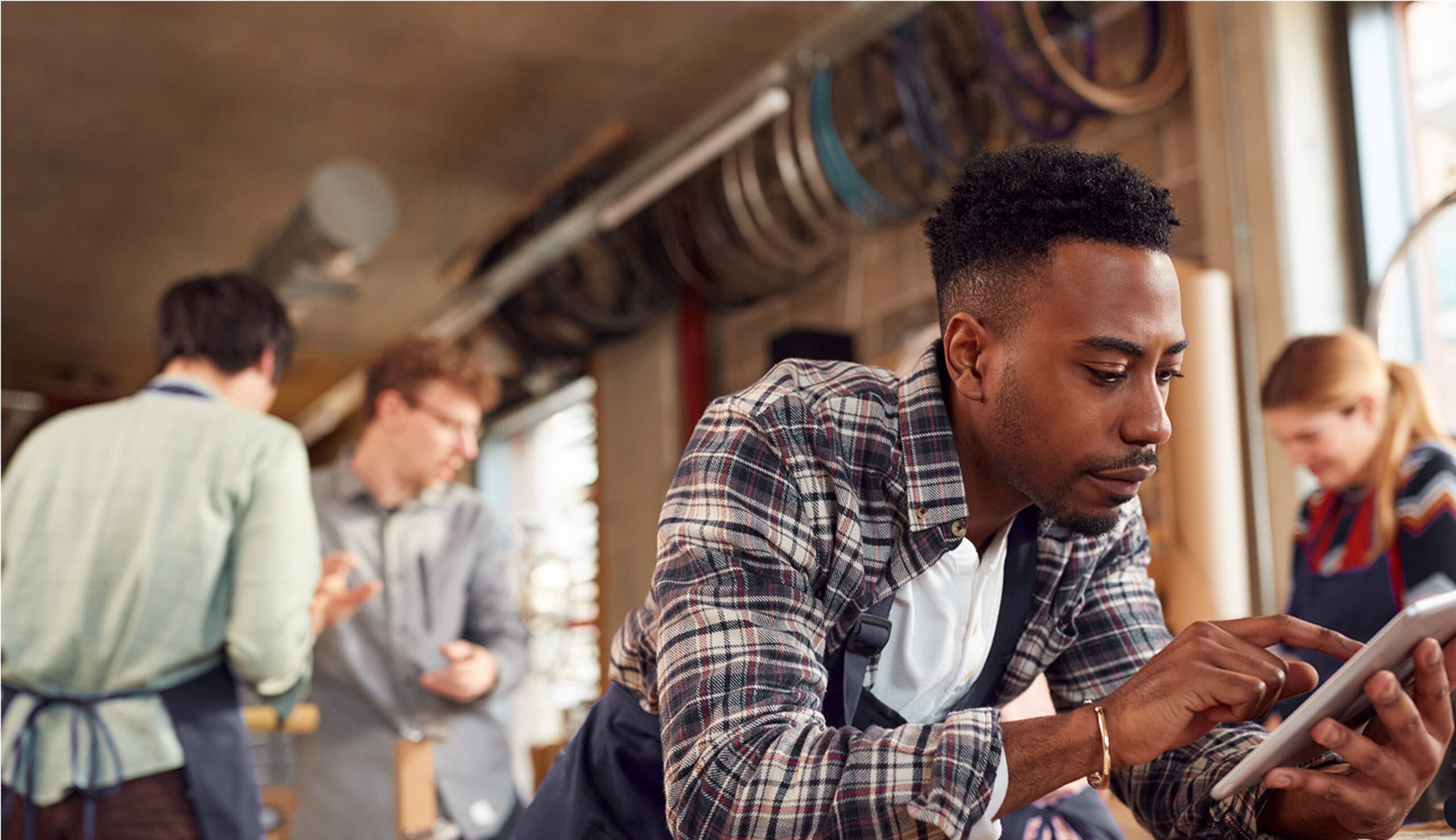 Business owner checking his phone at his place of business