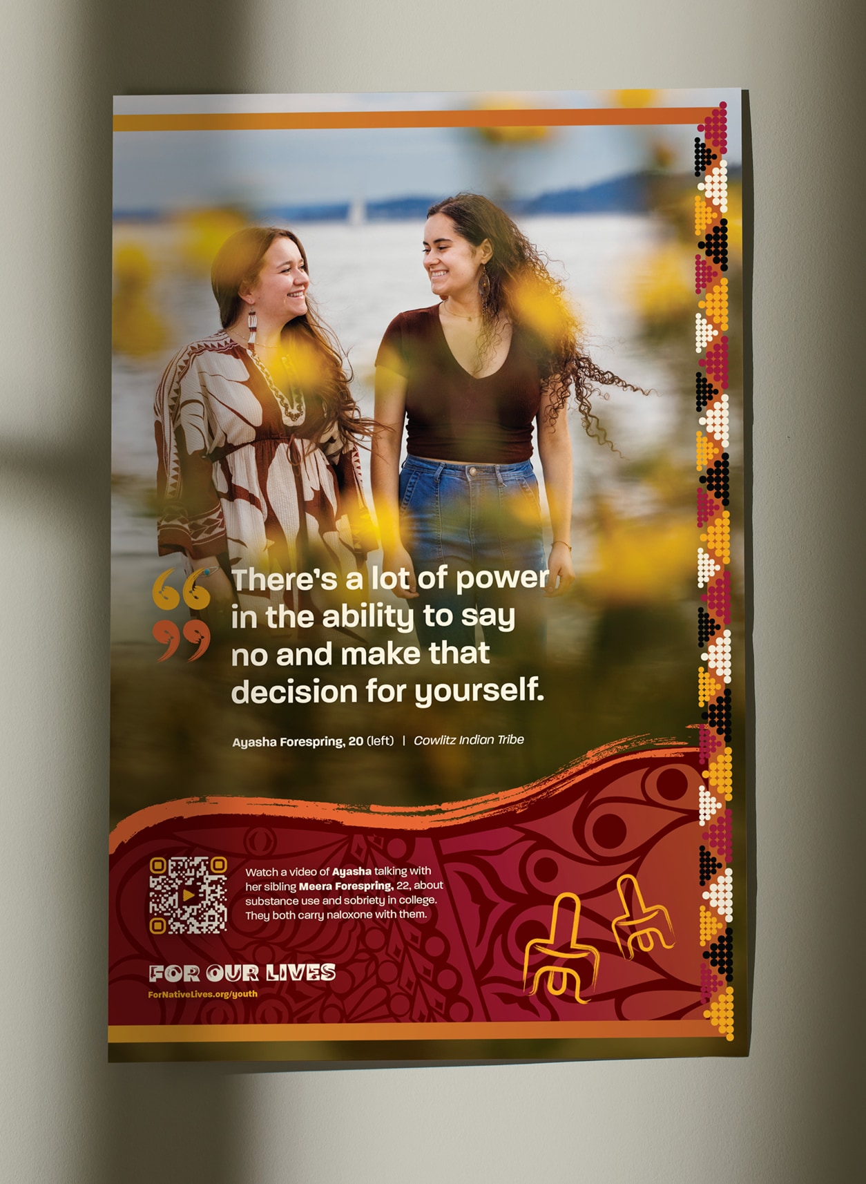 A photo of a poster hanging on a wall. The poster features a photo of siblings Ayasha and Meera Forespring smiling at each other by the water, with a quote from Ayasha: 'There's a lot of power in the ability to say no and make that decision for yourself.'