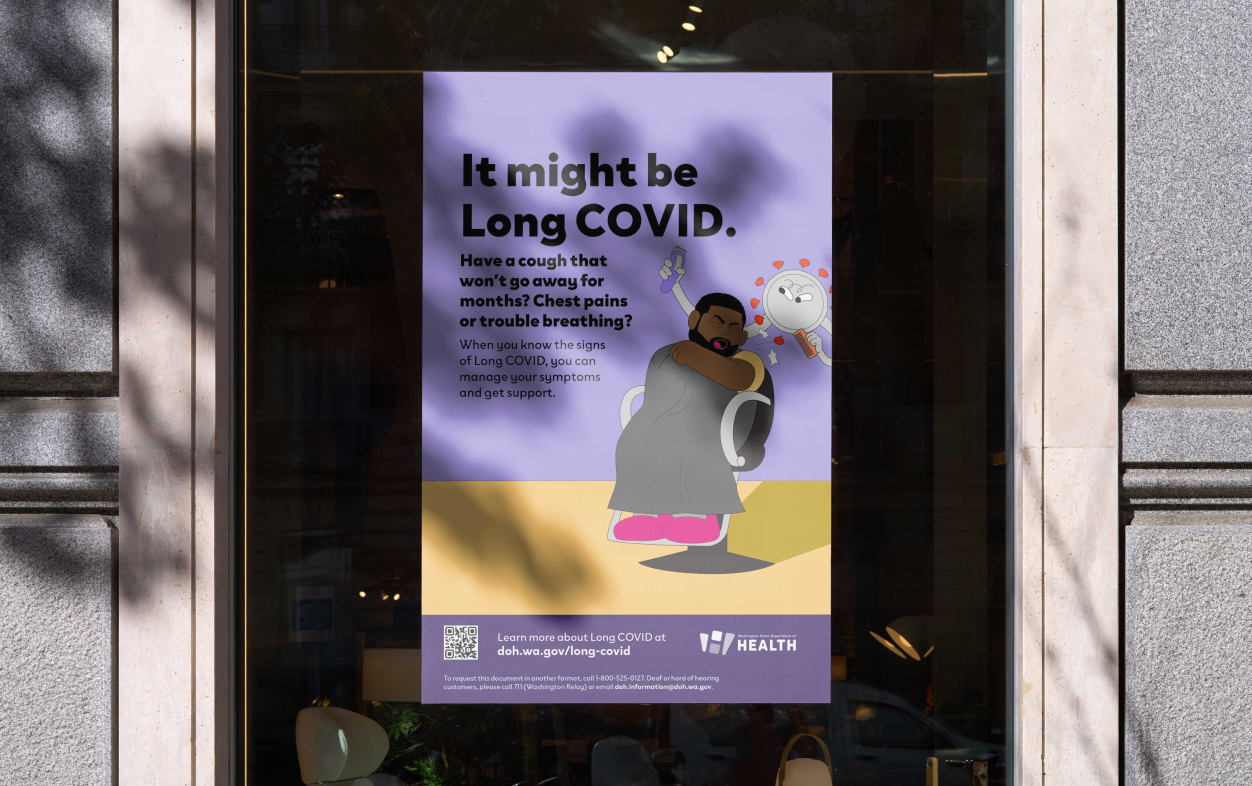 A photo of a poster hanging in a window. The poster reads, “It might be Long COVID. Have a cough that won’t go away for months? Chest pains or trouble breathing? When you know the signs of Long COVID, you can manage your symptoms and get support.” On the poster is an illustration of a man sitting in a barber chair getting his hair cut. He is coughing. The barber is a shapeshifting creature representing Long COVID, holding clippers and a comb. 