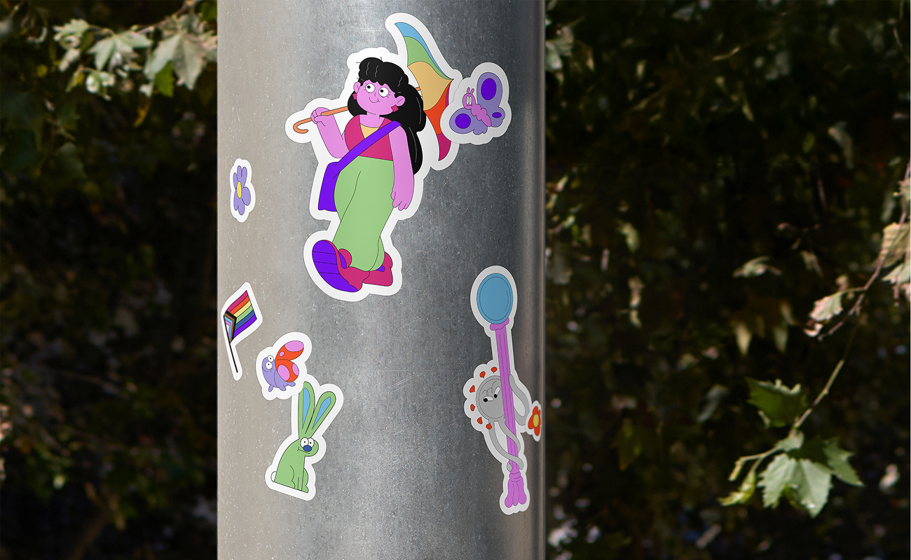A photo of six small stickers on a metal pole. The stickers feature illustrated characters, including the shapeshifting Long COVID character, a woman walking with a rainbow umbrella and a Pride flag. 