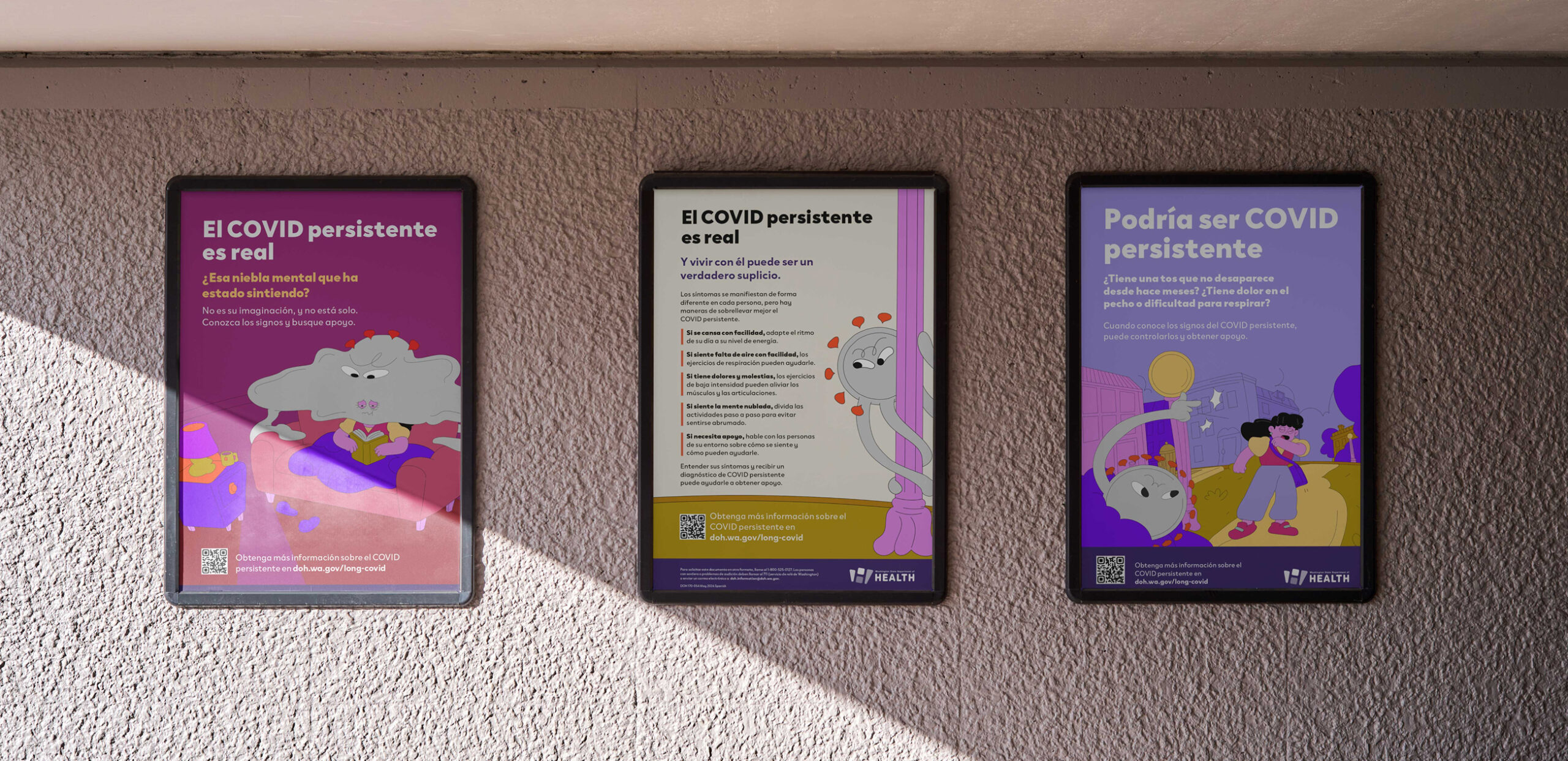 A photo of three posters hanging on an exterior wall. The three posters are in Spanish and describe the most common symptoms of and care options for Long COVID. 